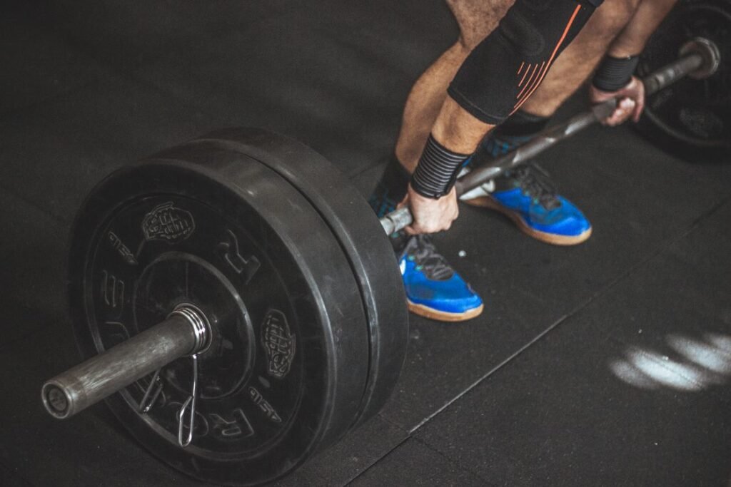 Man gripping a barbell, testing the grip strength linked to longevity