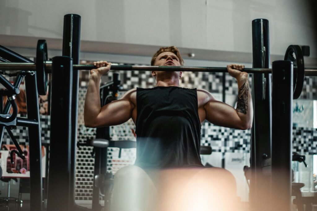 man performing a barbell deadlift, one of the best compound exercises