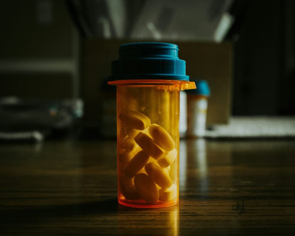 sleep supplements and a glass of water on a nightstand