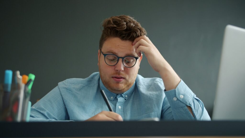 Tired man rubbing temples showing chronic stress symptoms