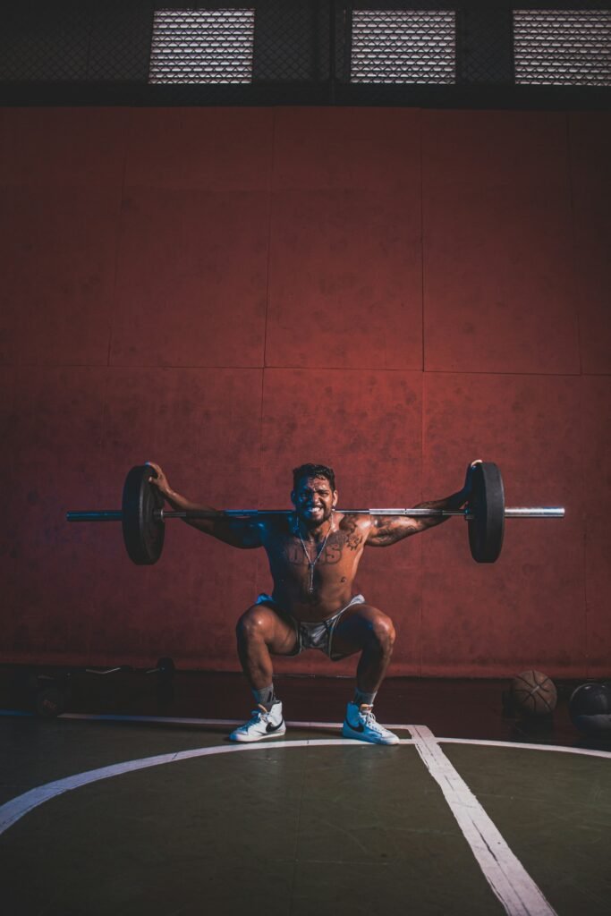 exercises to increase testosterone - man performing a heavy barbell squat in a gym