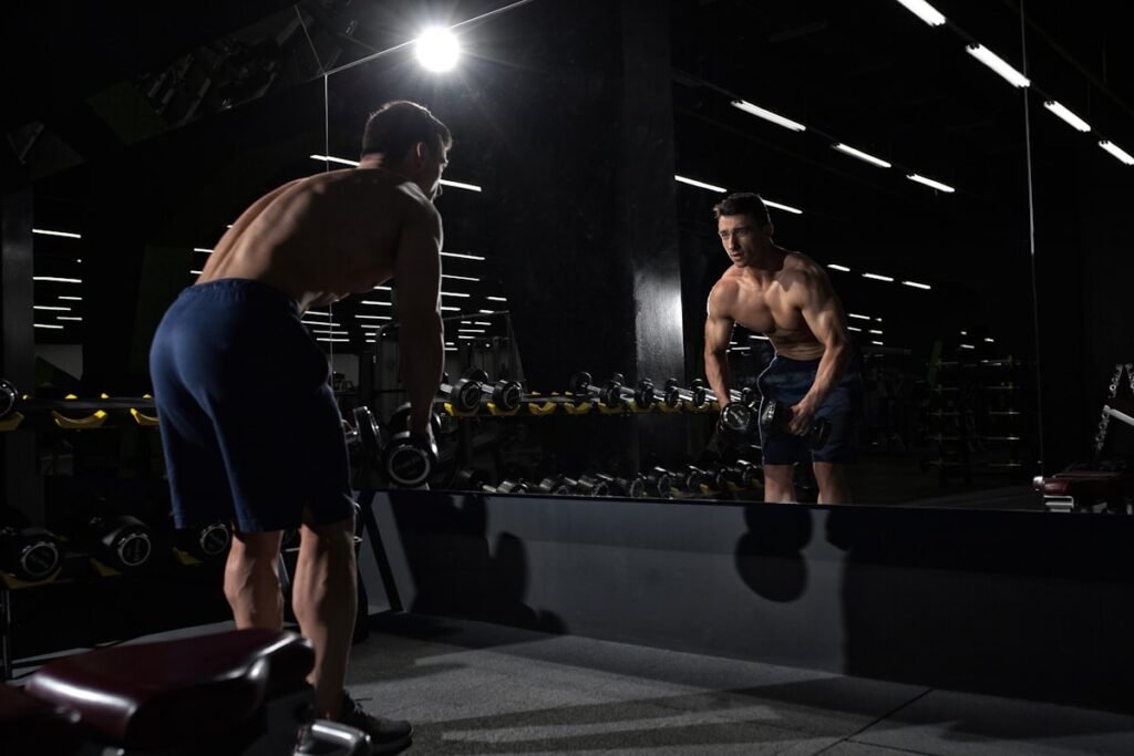 man warming up properly to avoid gym injuries before lifting weights