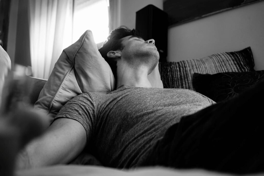 man sleeping peacefully in a cool dark bedroom
