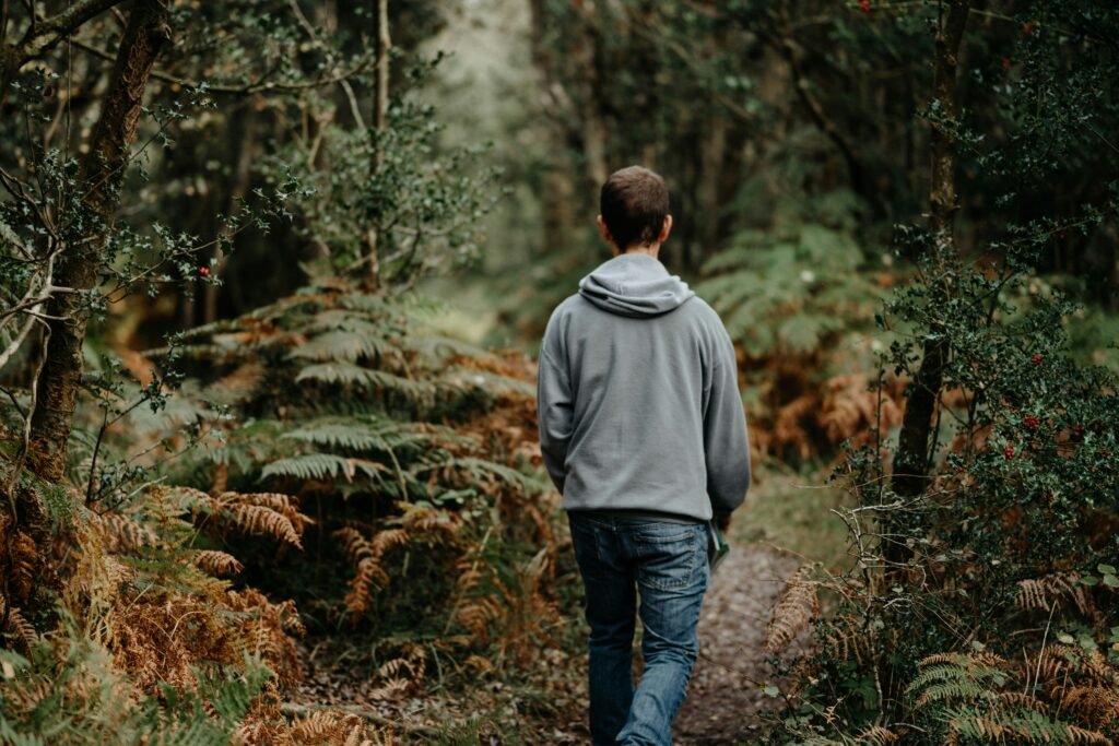 Man walking outdoors practicing how to manage stress