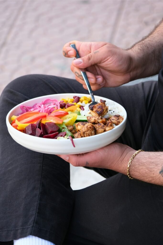man eating a protein-rich meal illustrating meal timing and protein timing