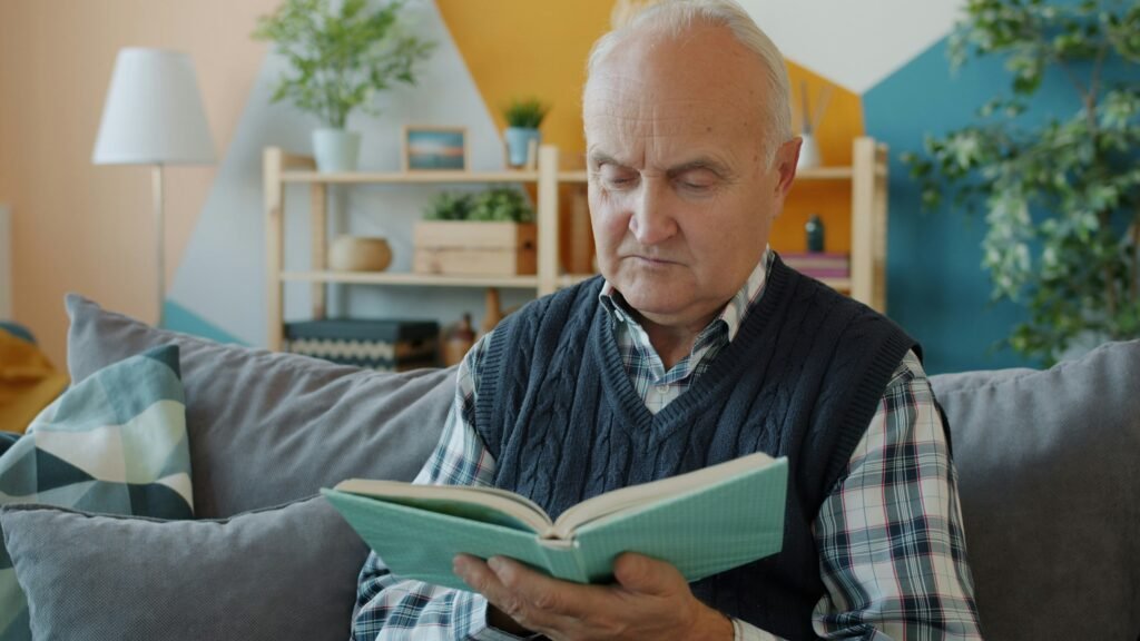 older man reading, engaged and sharp, practicing how to prevent cognitive decline