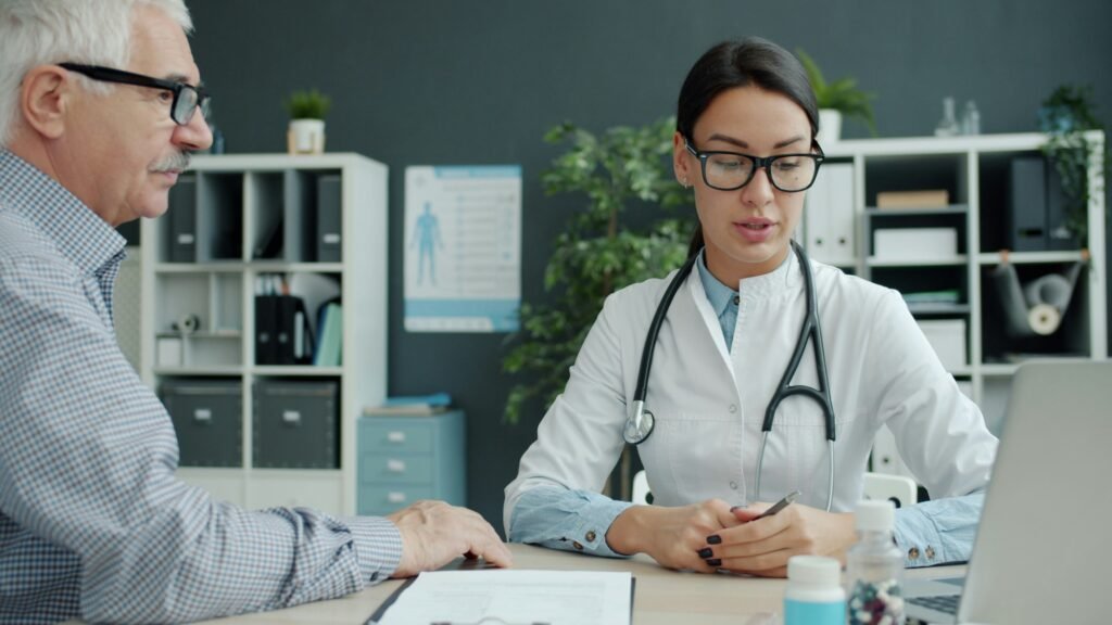 Older man in doctor consultation discussing prostate cancer vs BPH