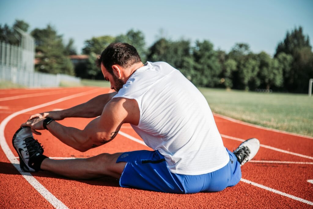 Man stretching and foam rolling during recovery after 40