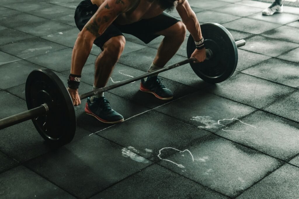 older man lifting weights as part of sarcopenia prevention training