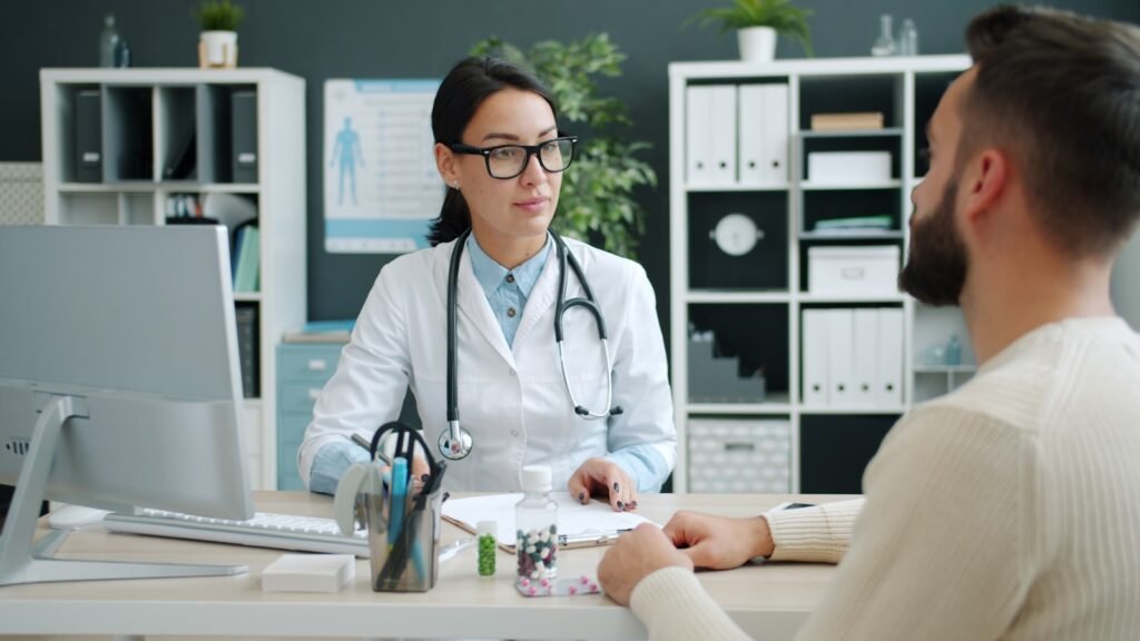 testosterone levels by age - doctor showing blood test results to male patient