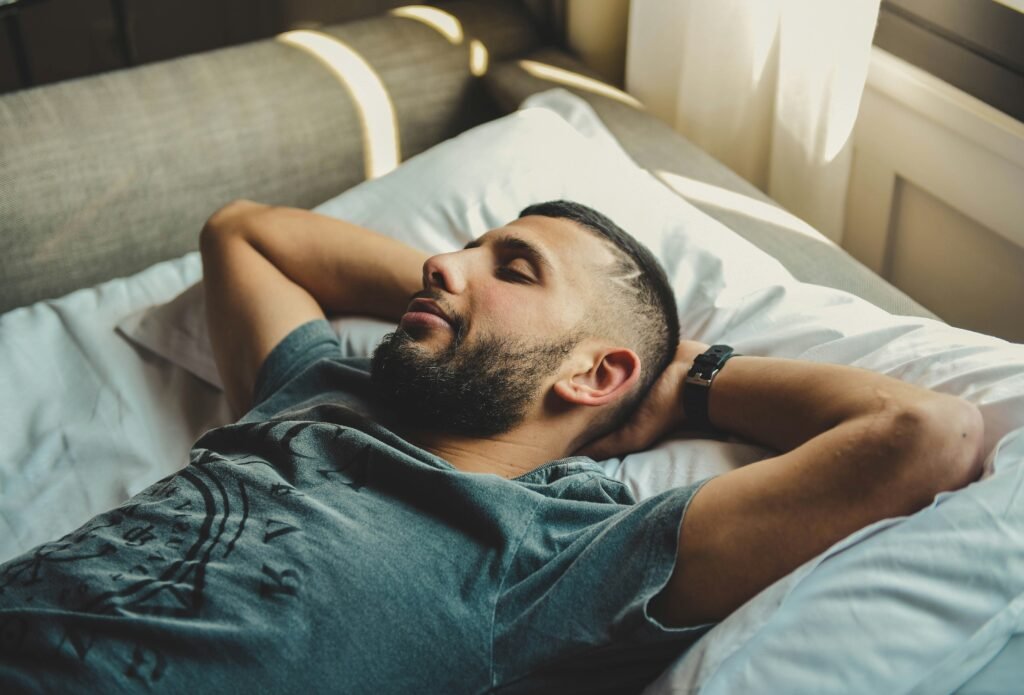 tired man awake in bed at night, illustrating common men sleep problems