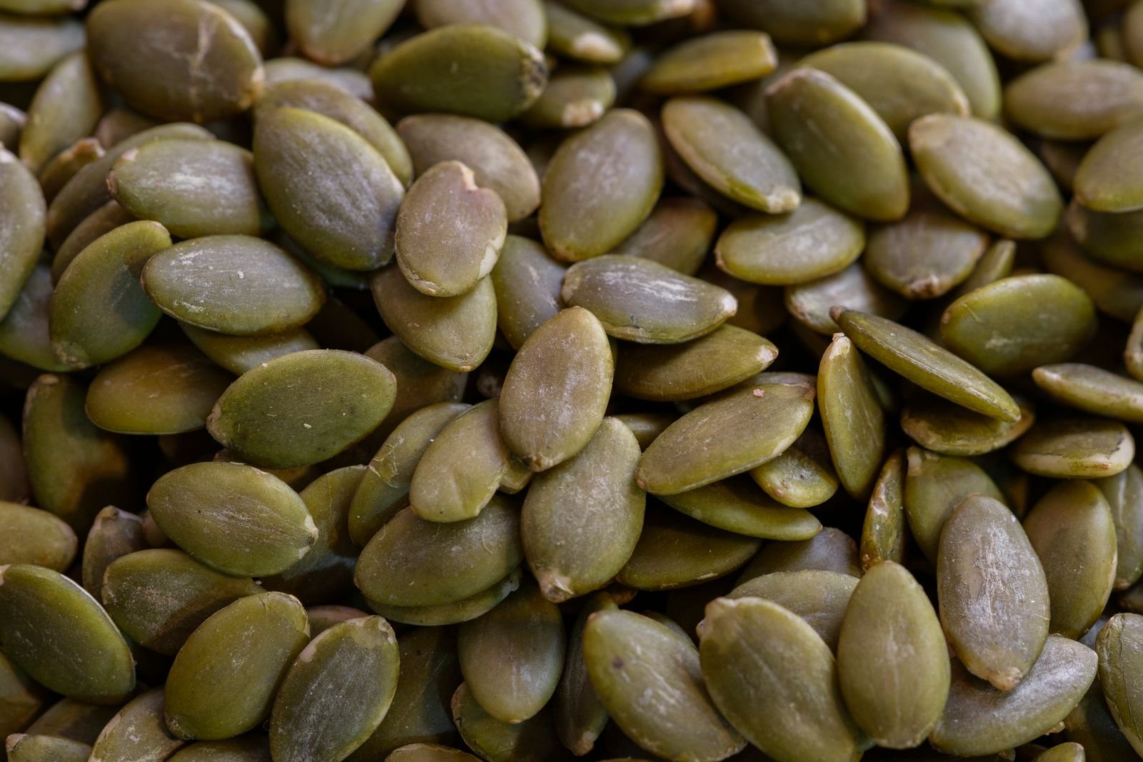A pile of green pumpkin seeds