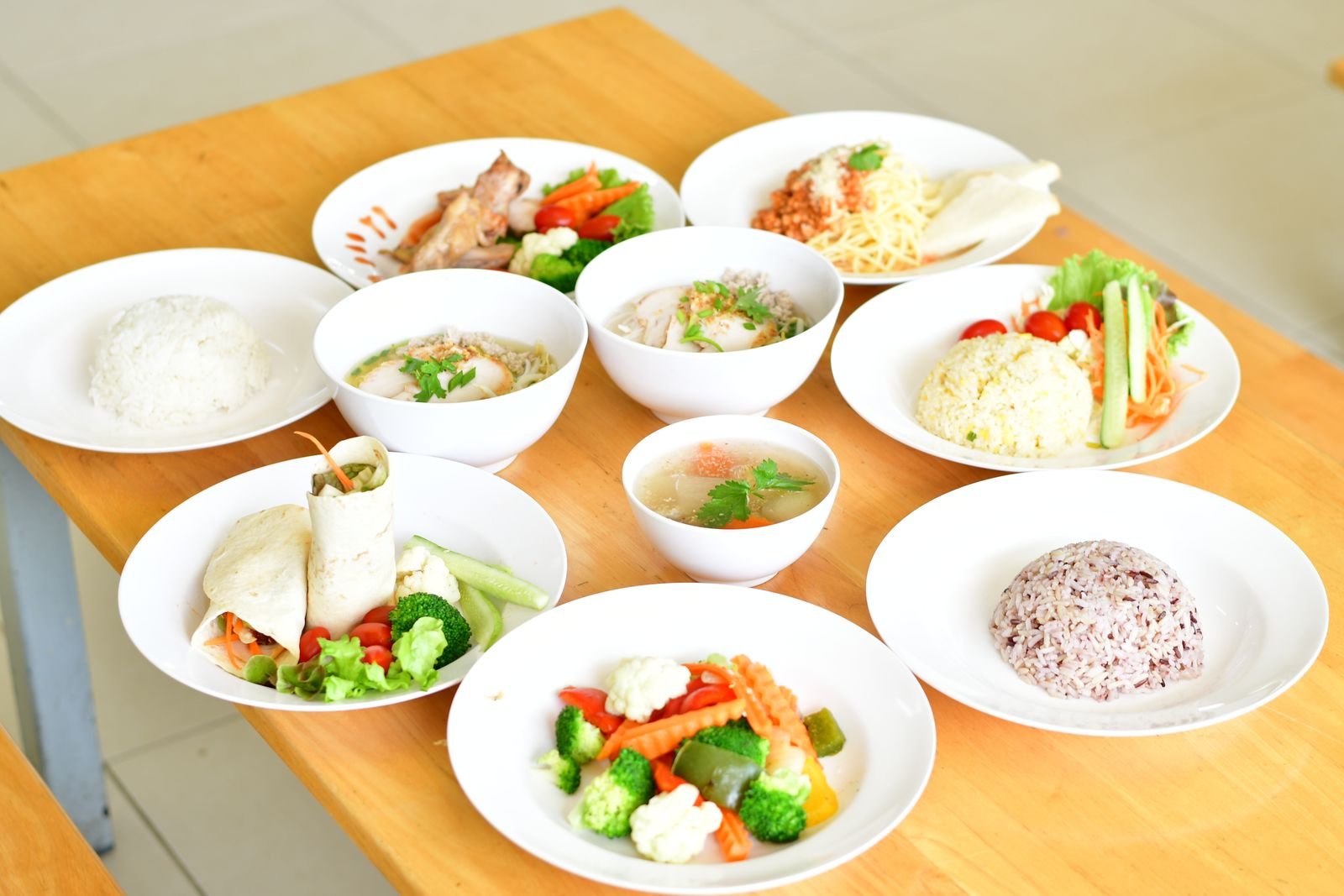 A table set with several plates of home-cooked, balanced meals