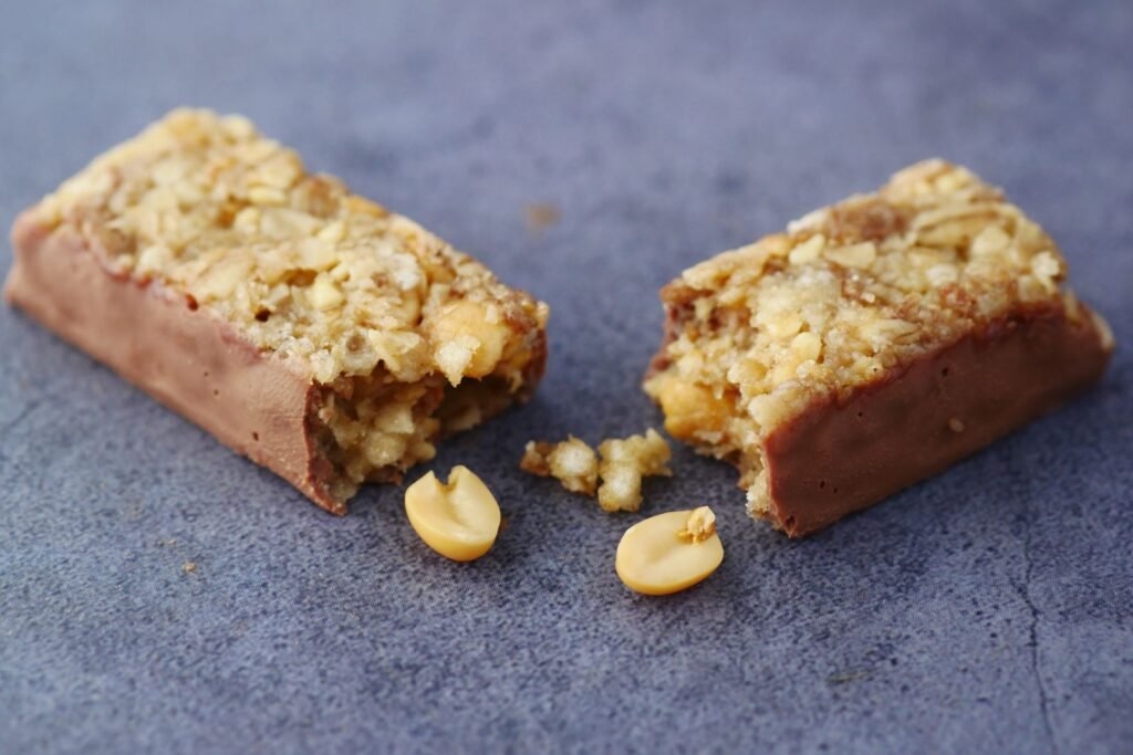Broken chocolate and nut protein bar on a surface