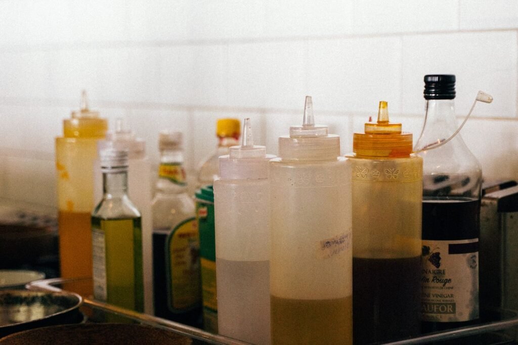 Glass bottles of cooking oil on a kitchen surface