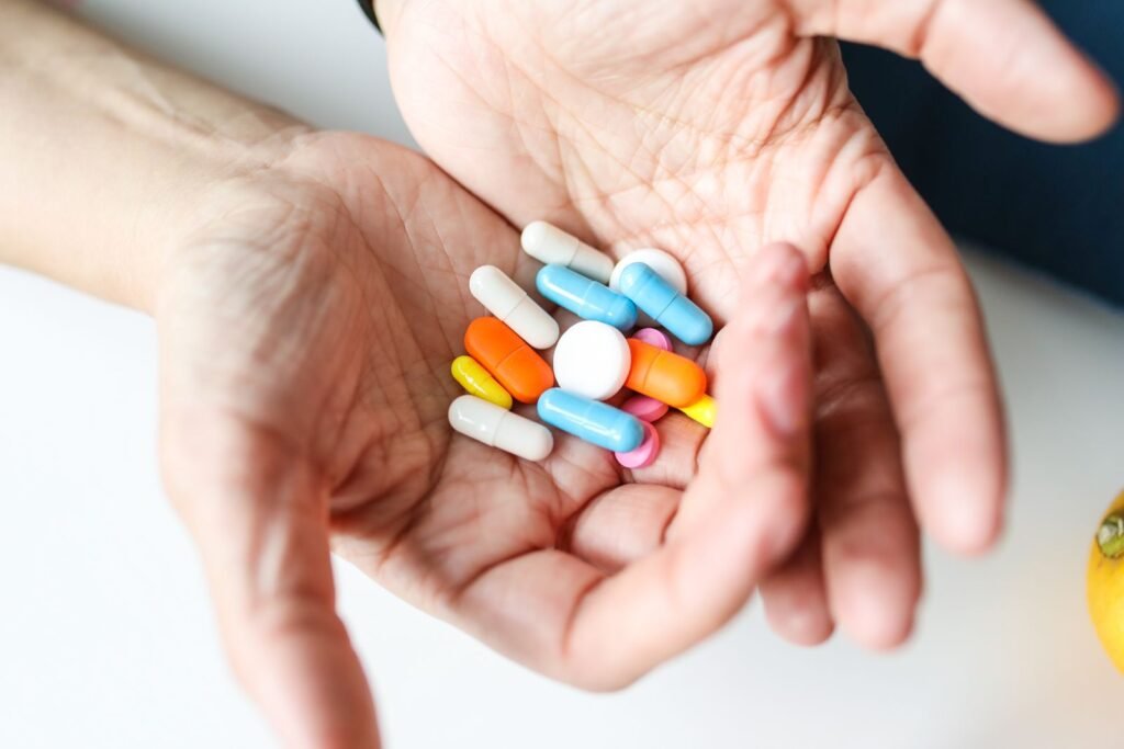 Assorted pills held in cupped hands