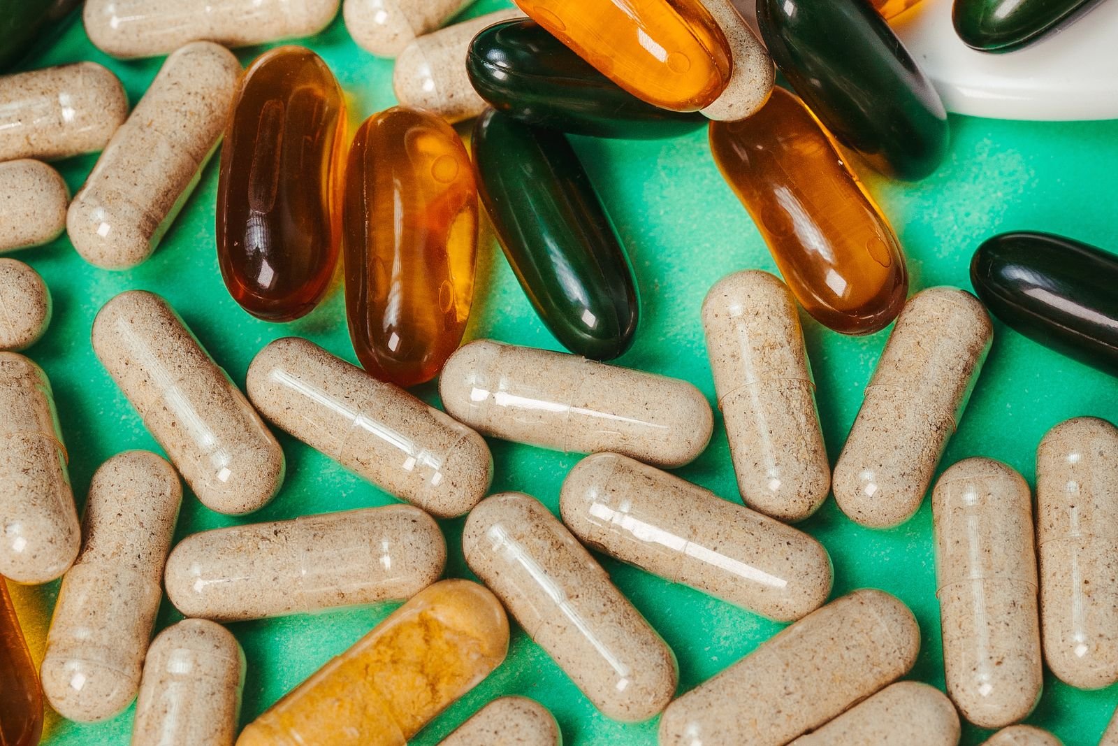 Assorted supplement capsules laid out on a surface
