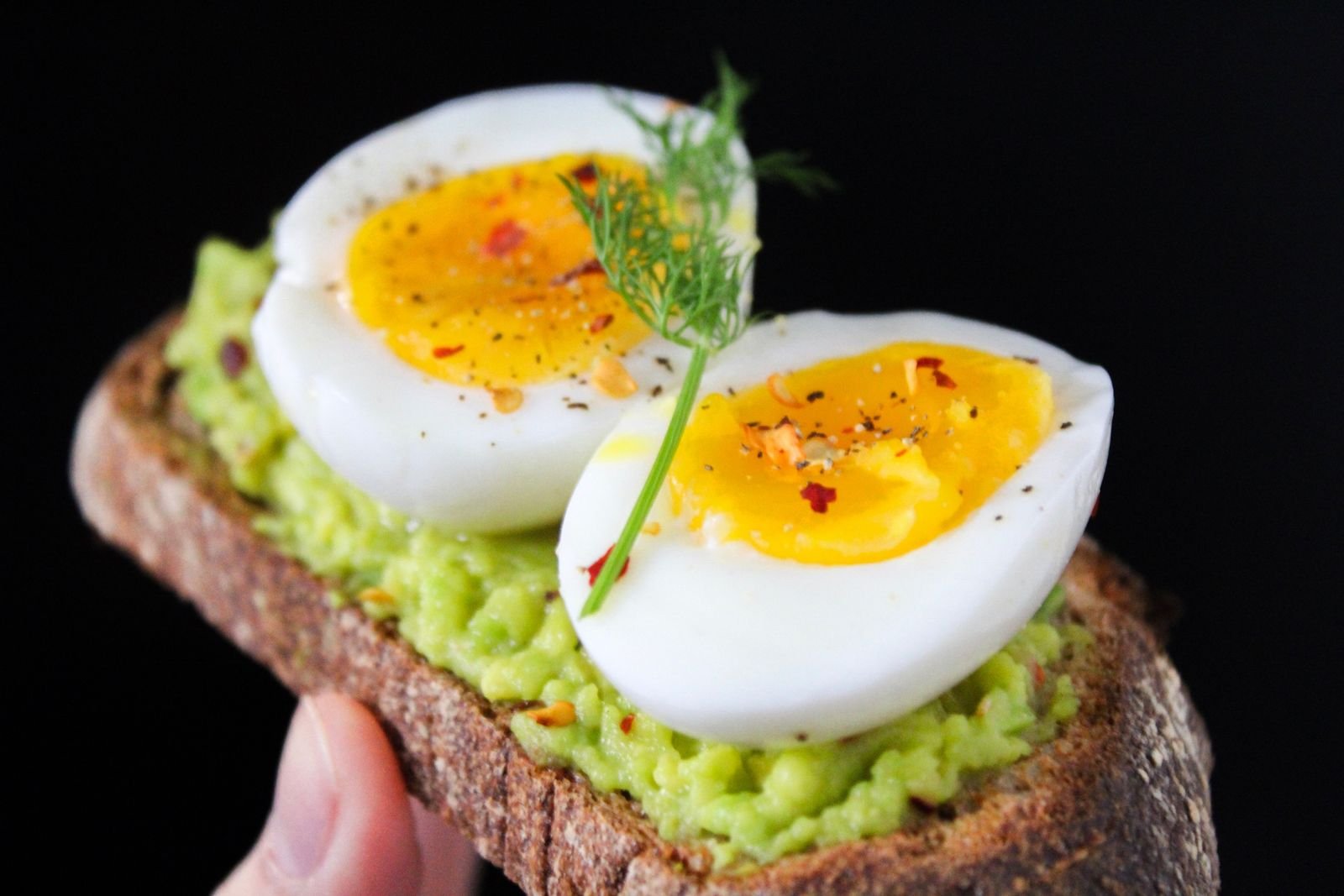 Avocado toast topped with soft-boiled eggs