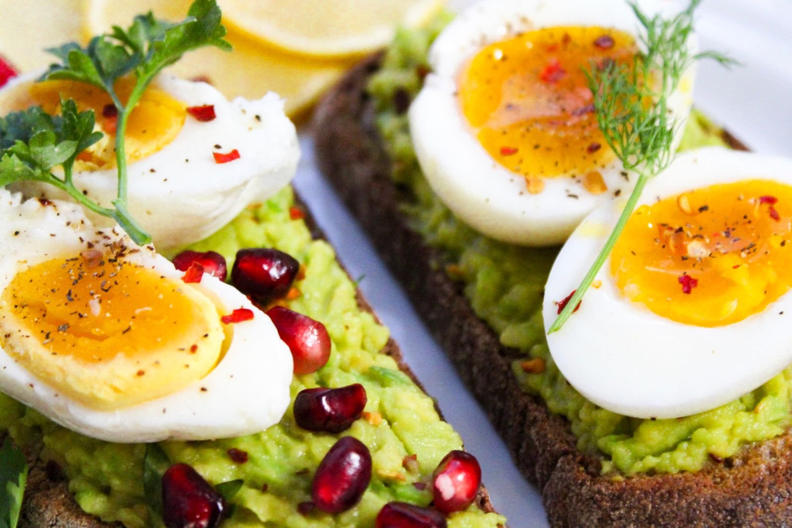 Avocado toast topped with soft-boiled eggs