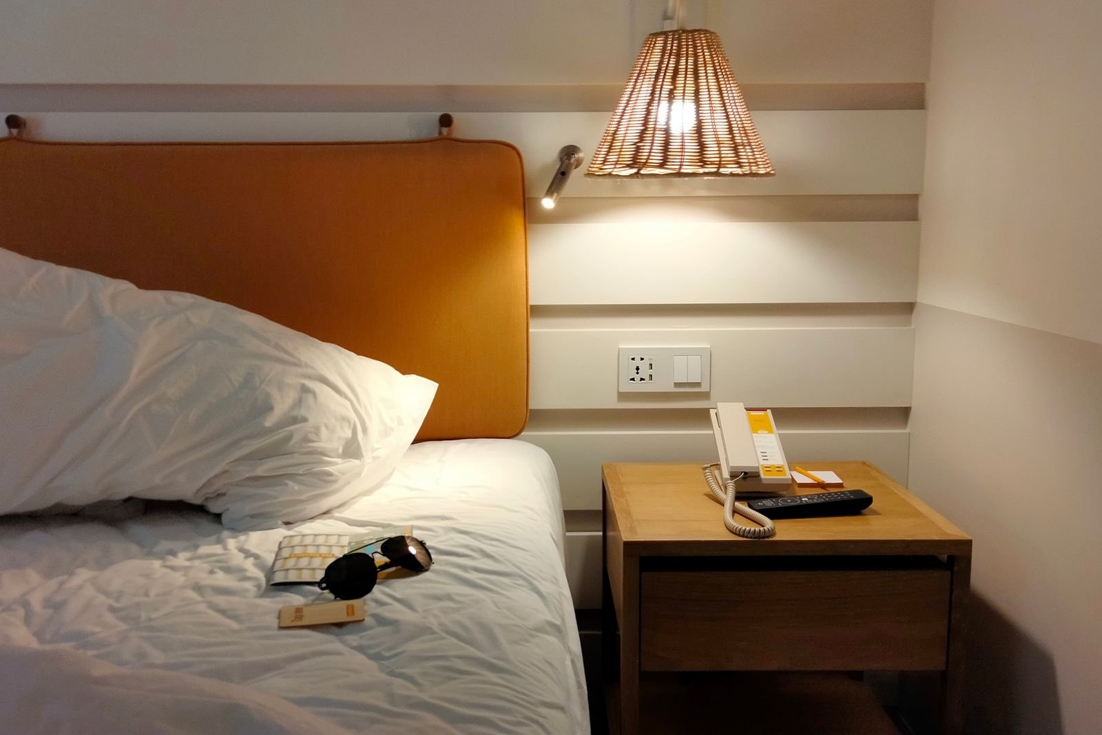 Bed with a bedside lamp switched on