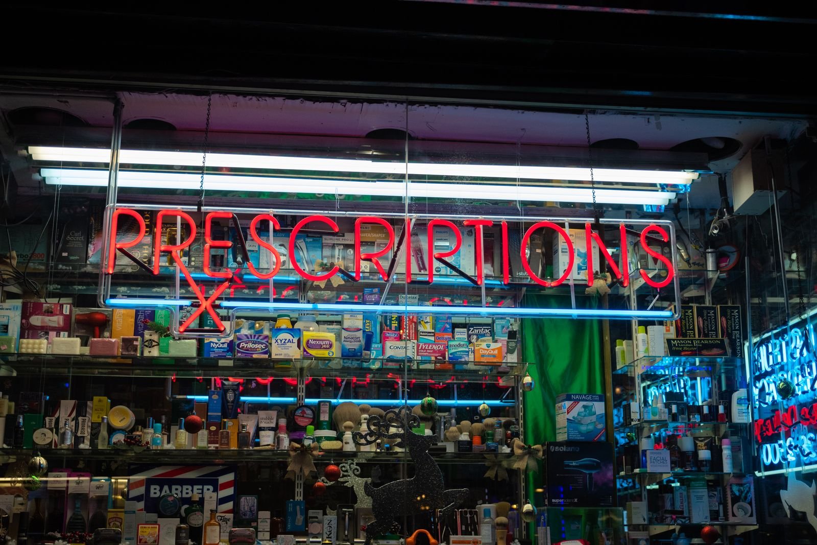 Brightly lit pharmacy storefront at night