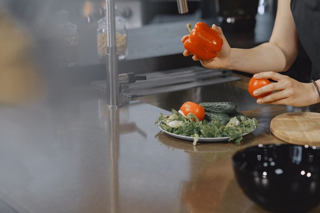 Person preparing fresh vegetables in a modern kitchen