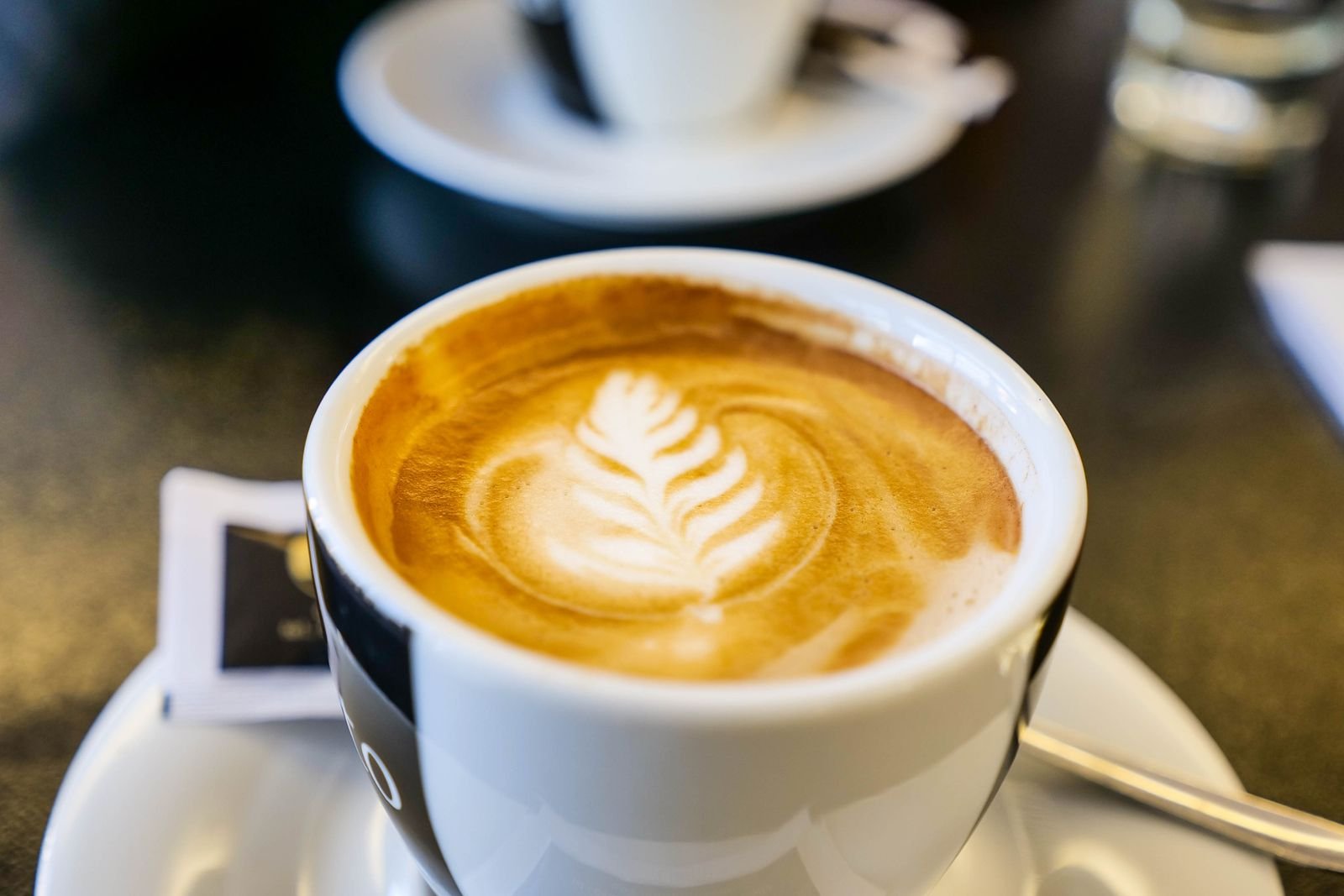 Cappuccino with latte art on a cafe table