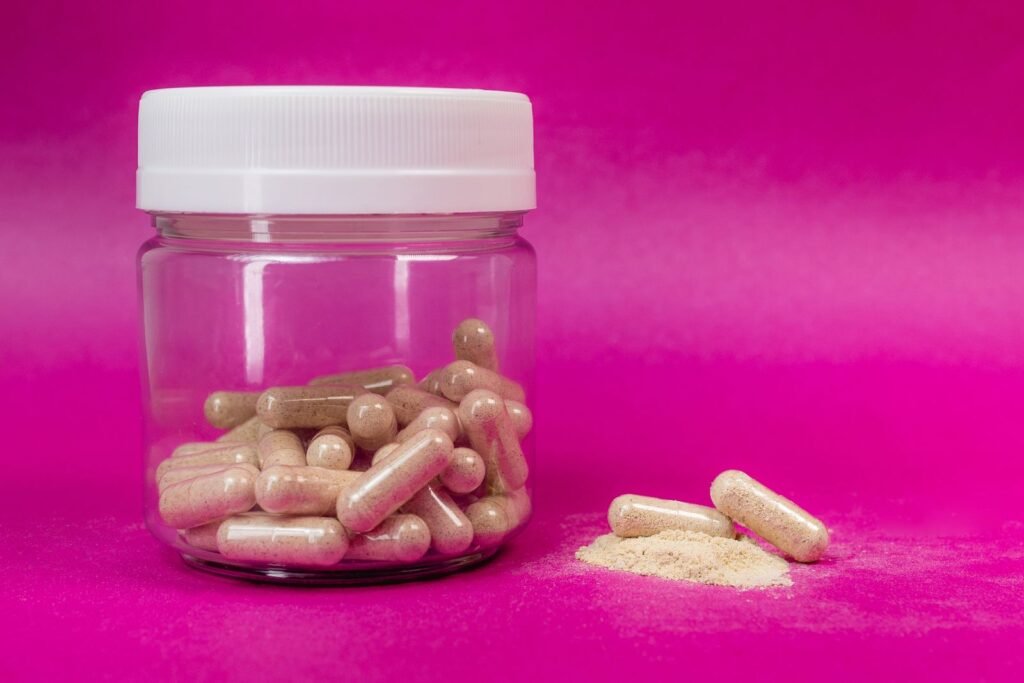 Jar of amino acid capsules and powder