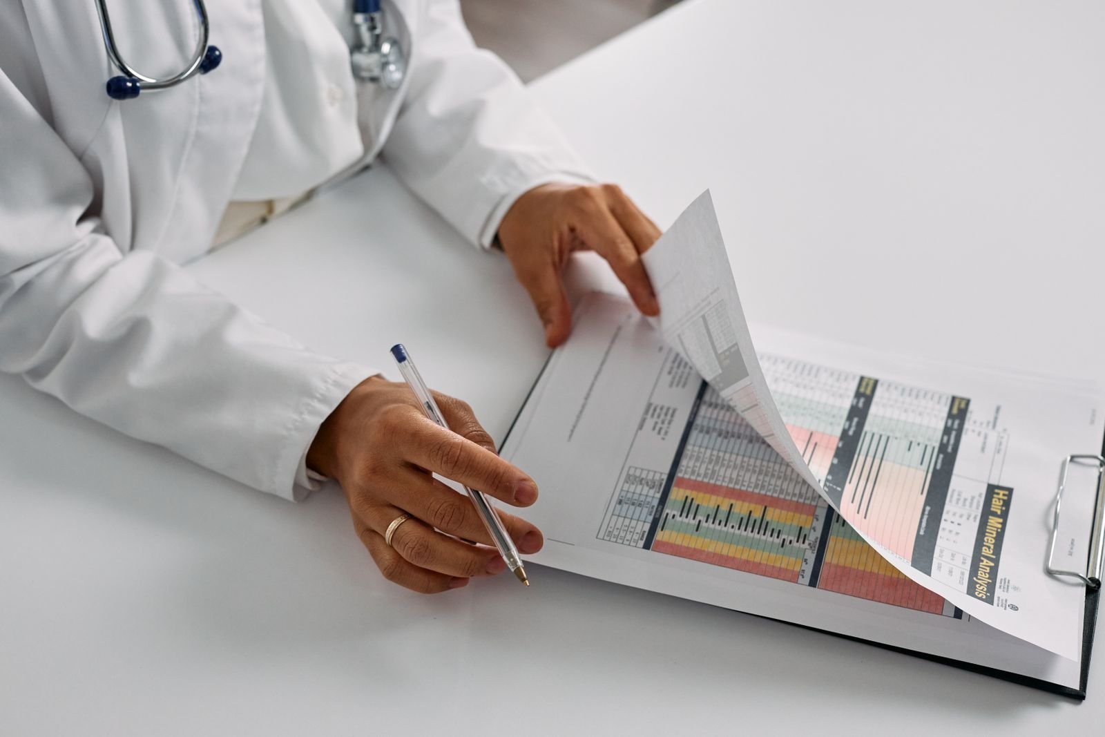 Clinician reviewing a patient report on a clipboard