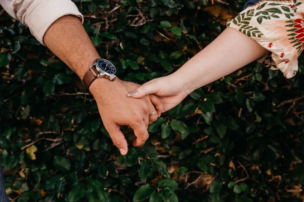Close-up of a couple holding hands outdoors