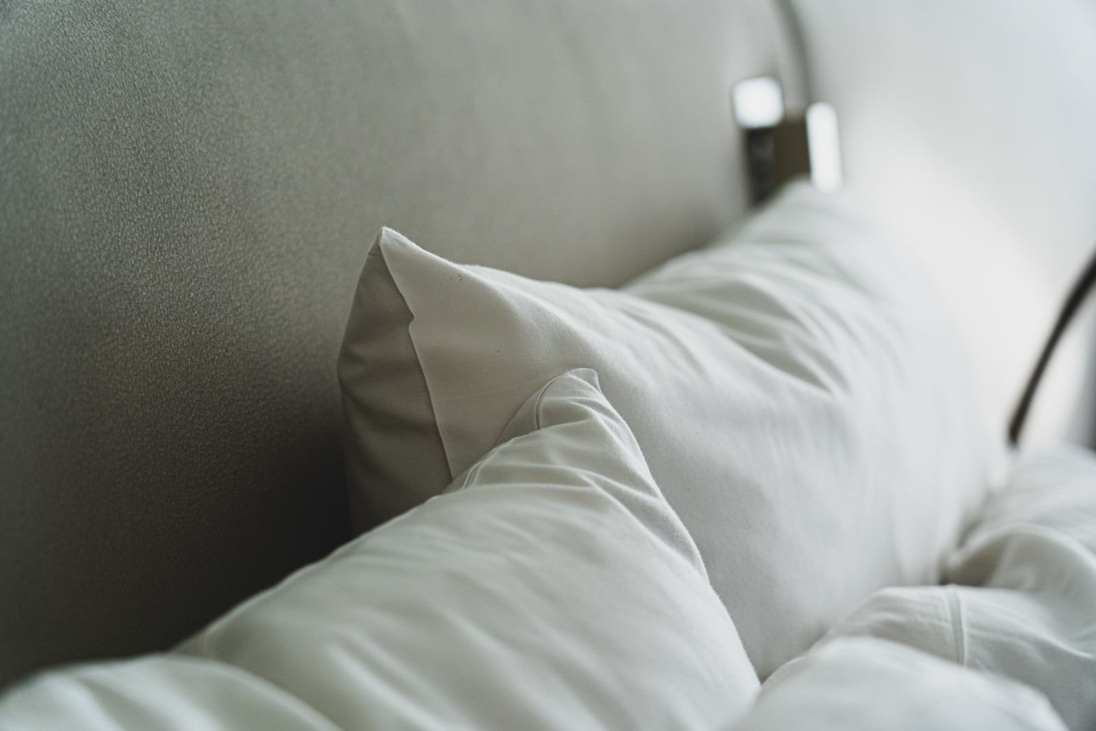 Close-up of white pillows on a bed