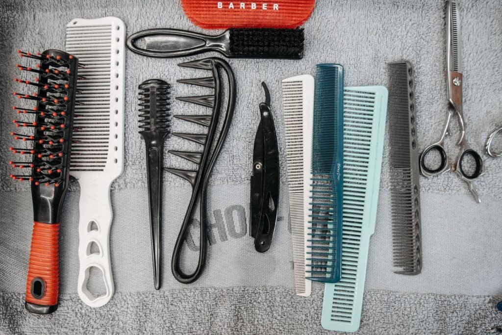Combs, brushes and scissors laid out on a towel