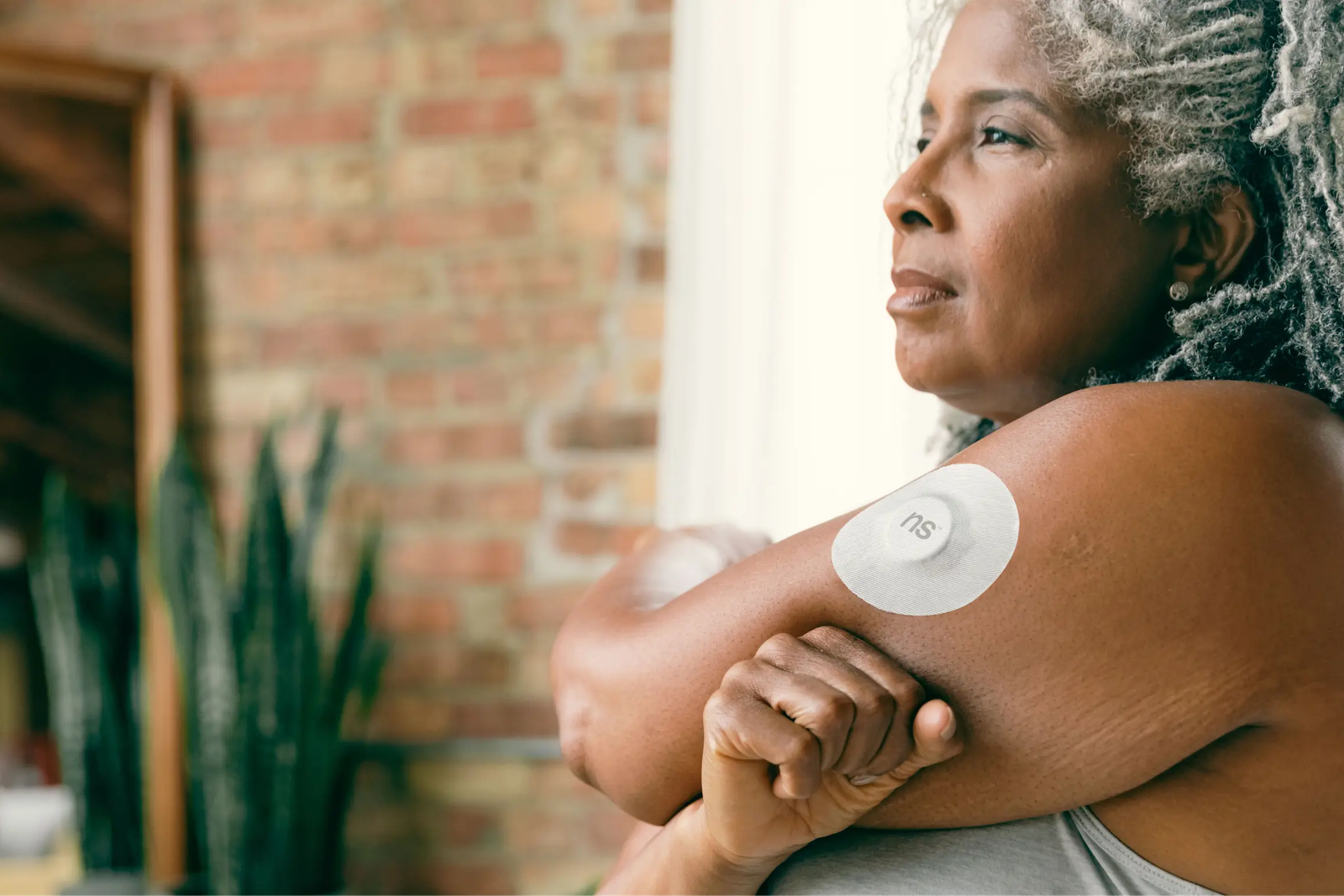 Continuous glucose monitor sensor worn on the upper arm