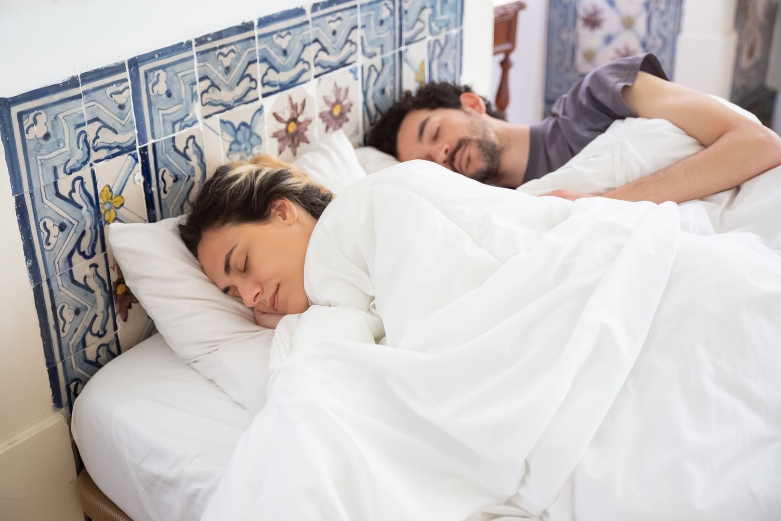 Couple asleep in a shared bed