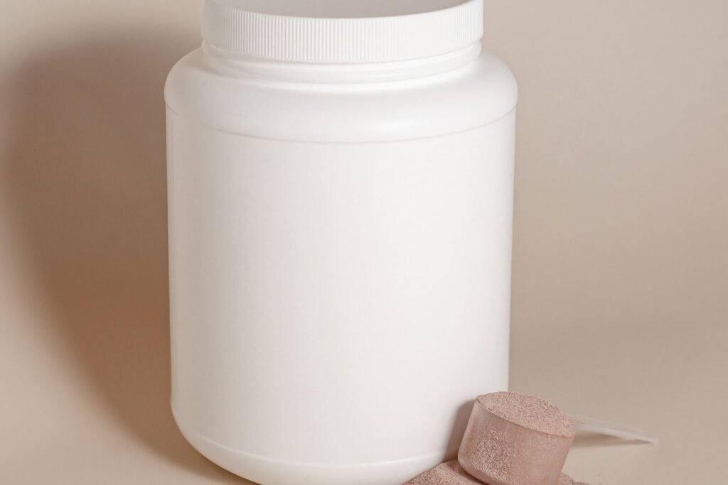 White container of powder with a measuring scoop