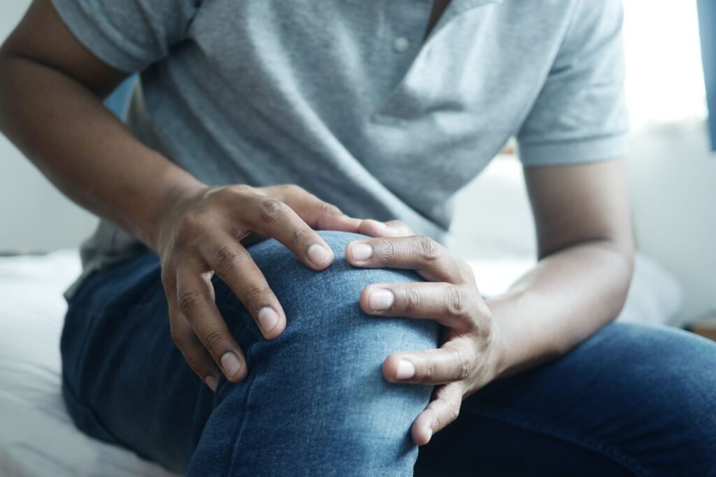 Man holding his sore knee