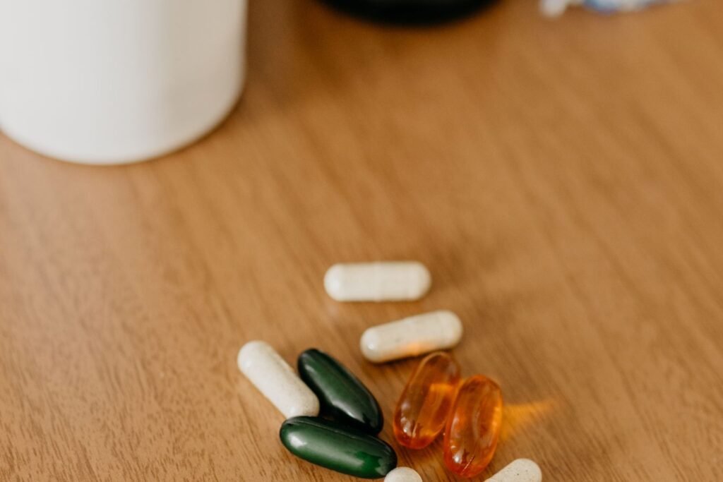 Assorted multivitamin capsules and bottles on a wooden table