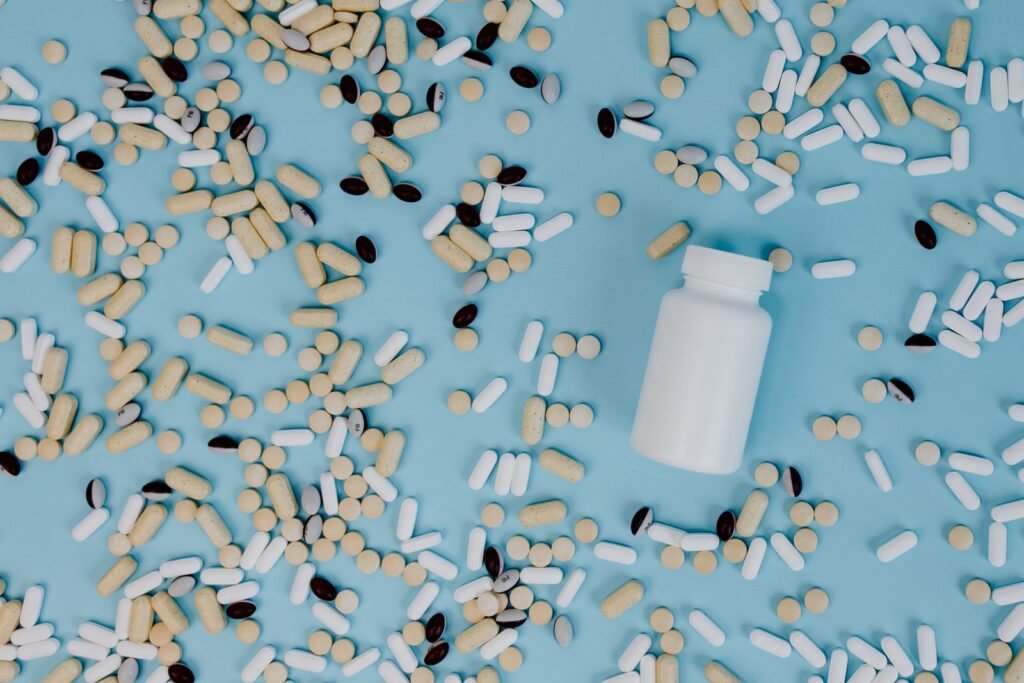 Tablets scattered around a white supplement bottle