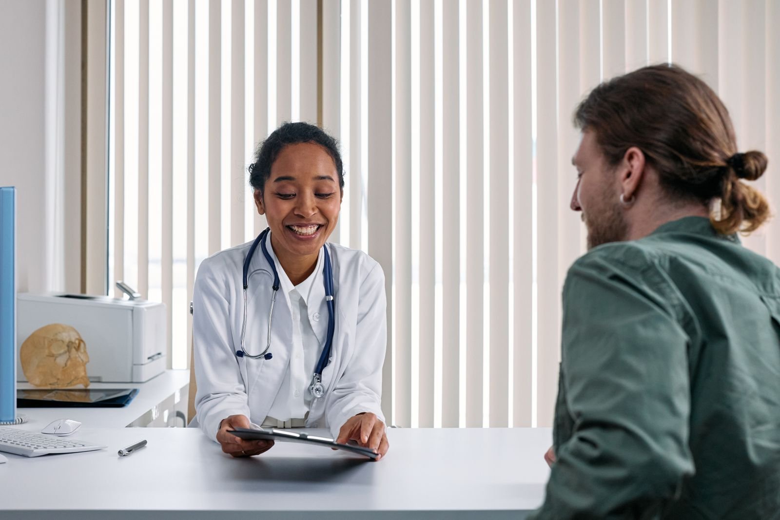 Doctor and male patient talking during a clinic consultation