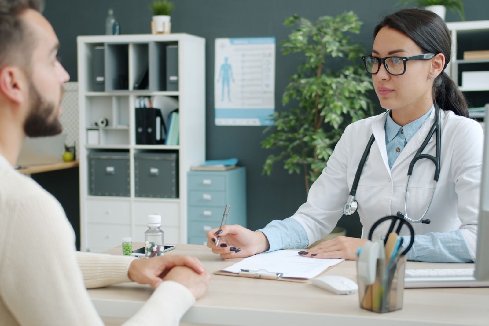 Doctor and male patient talking in a modern clinic
