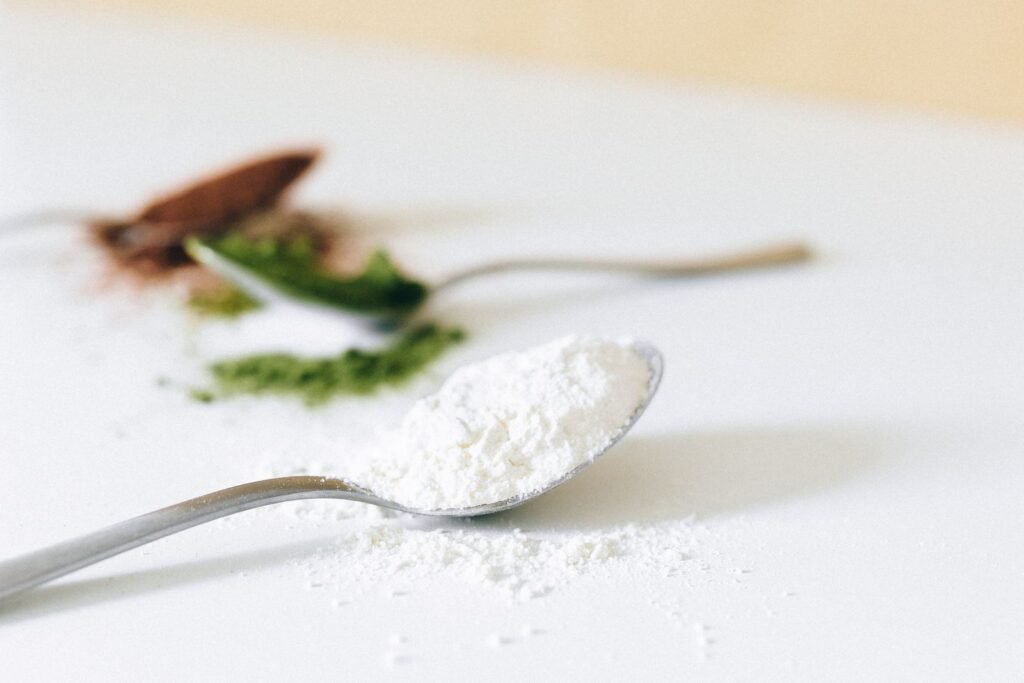 Spoons of powdered supplements