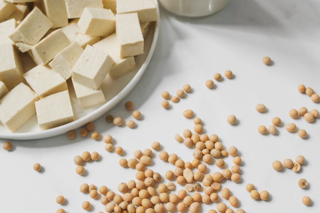 Tofu cubes, soybeans and soy milk on a table