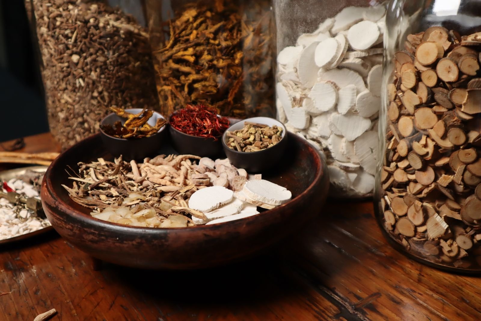 Dried roots and herbs in a wooden bowl