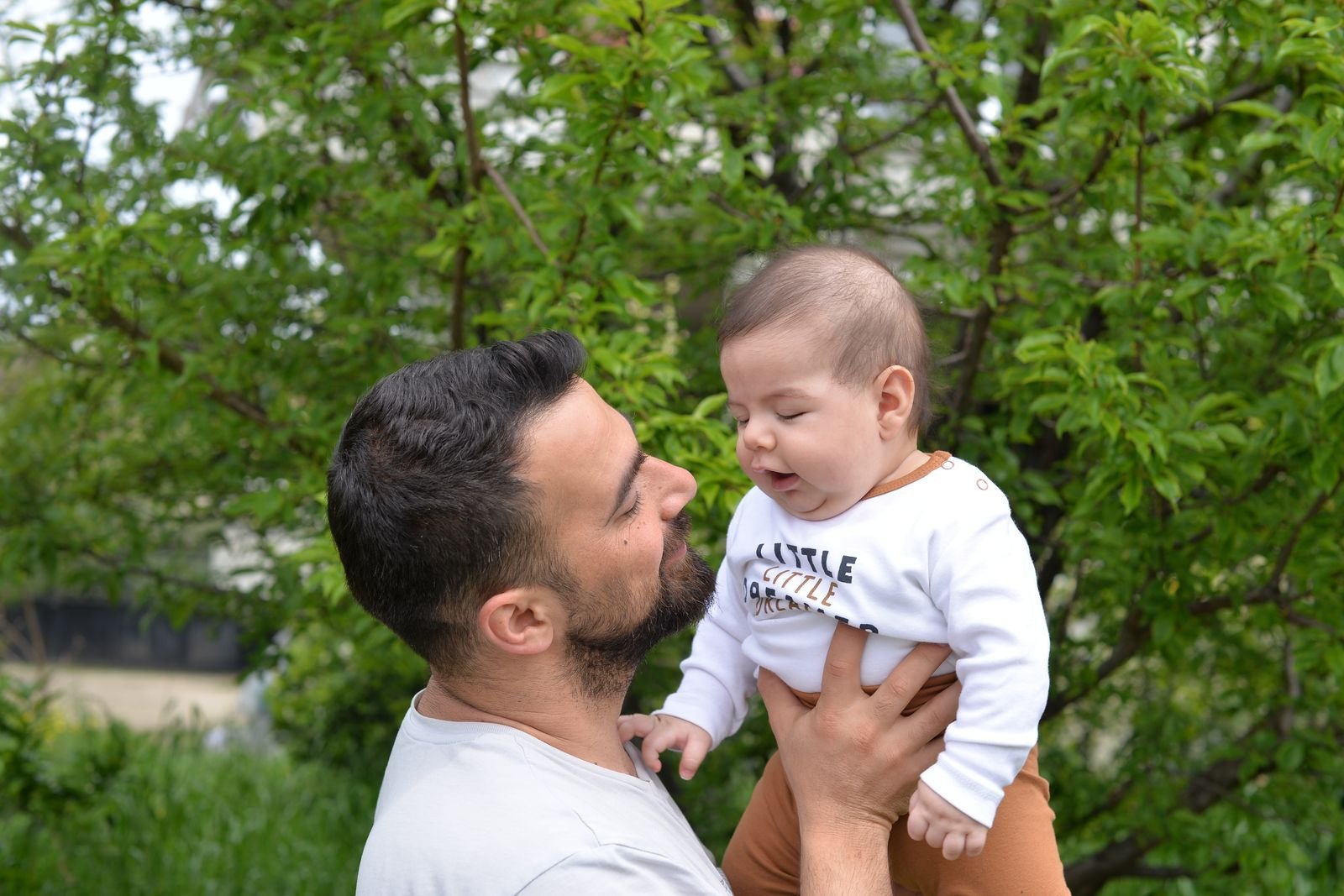 Father holding his baby son outdoors