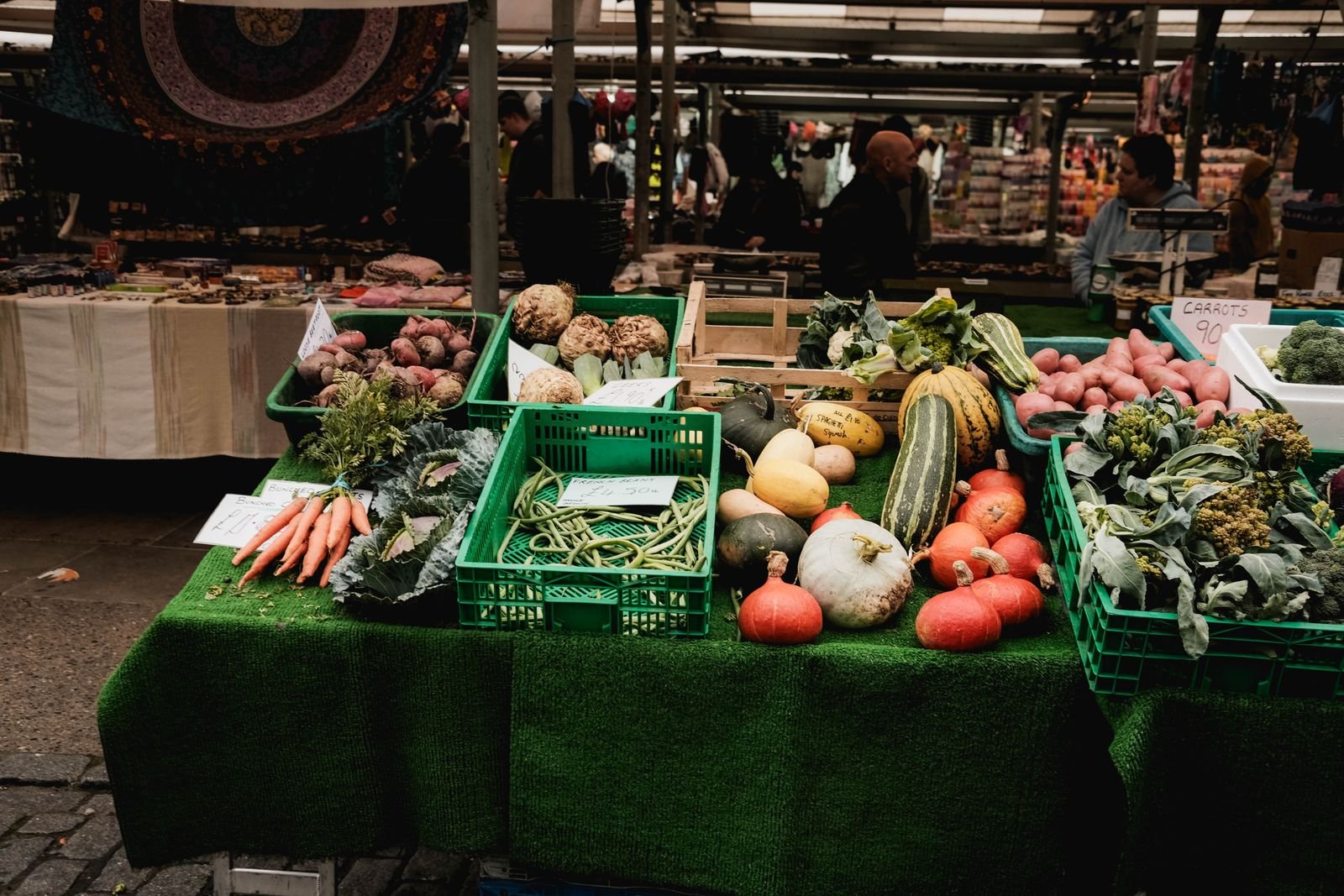 Fresh vegetables piled high at a farmers market
