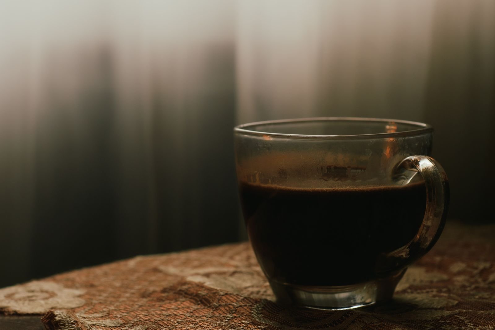 Glass cup of black coffee on a table