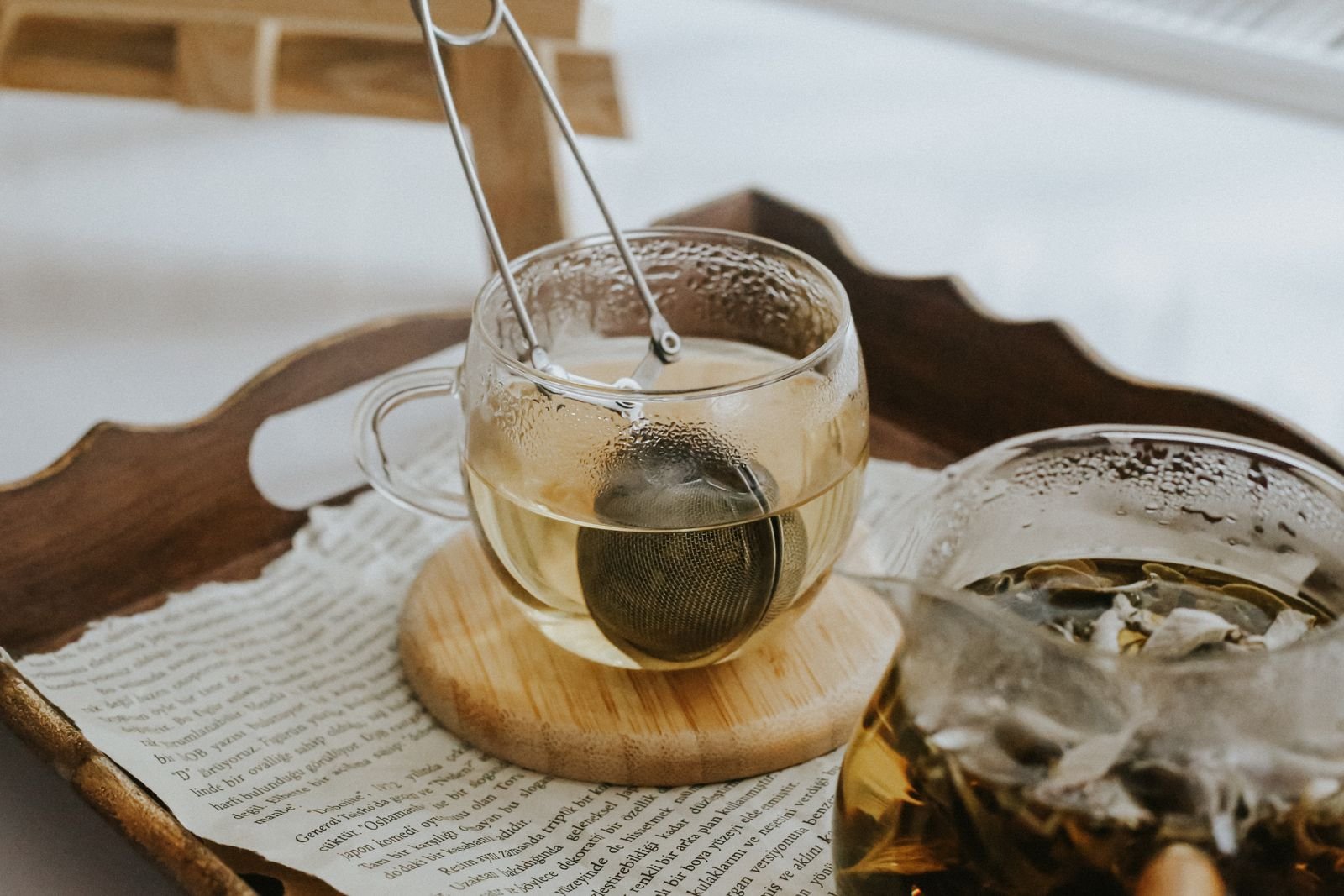 Glass cups of herbal tea on a tray in the evening
