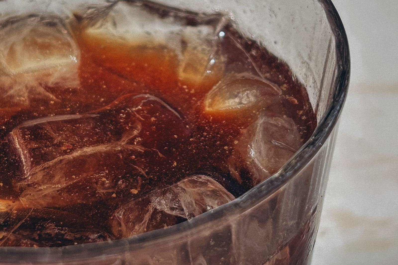 Glass of cola poured over ice