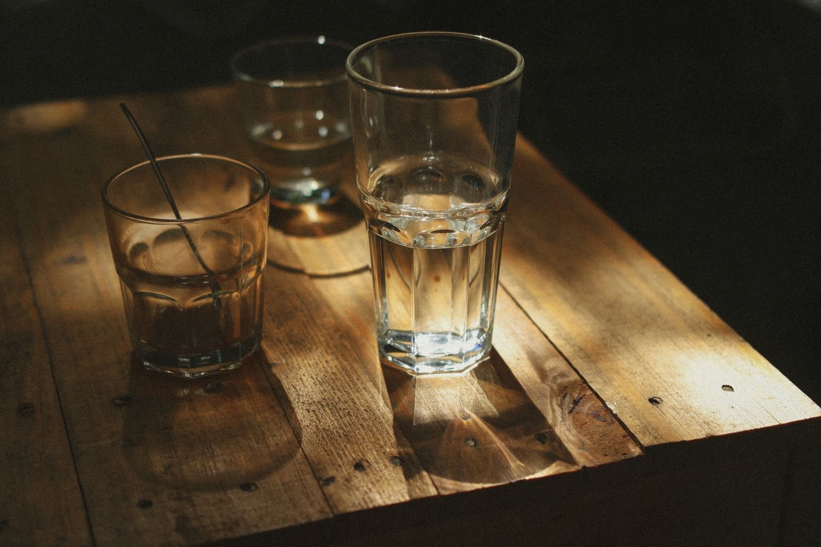 Glasses of water on a wooden table