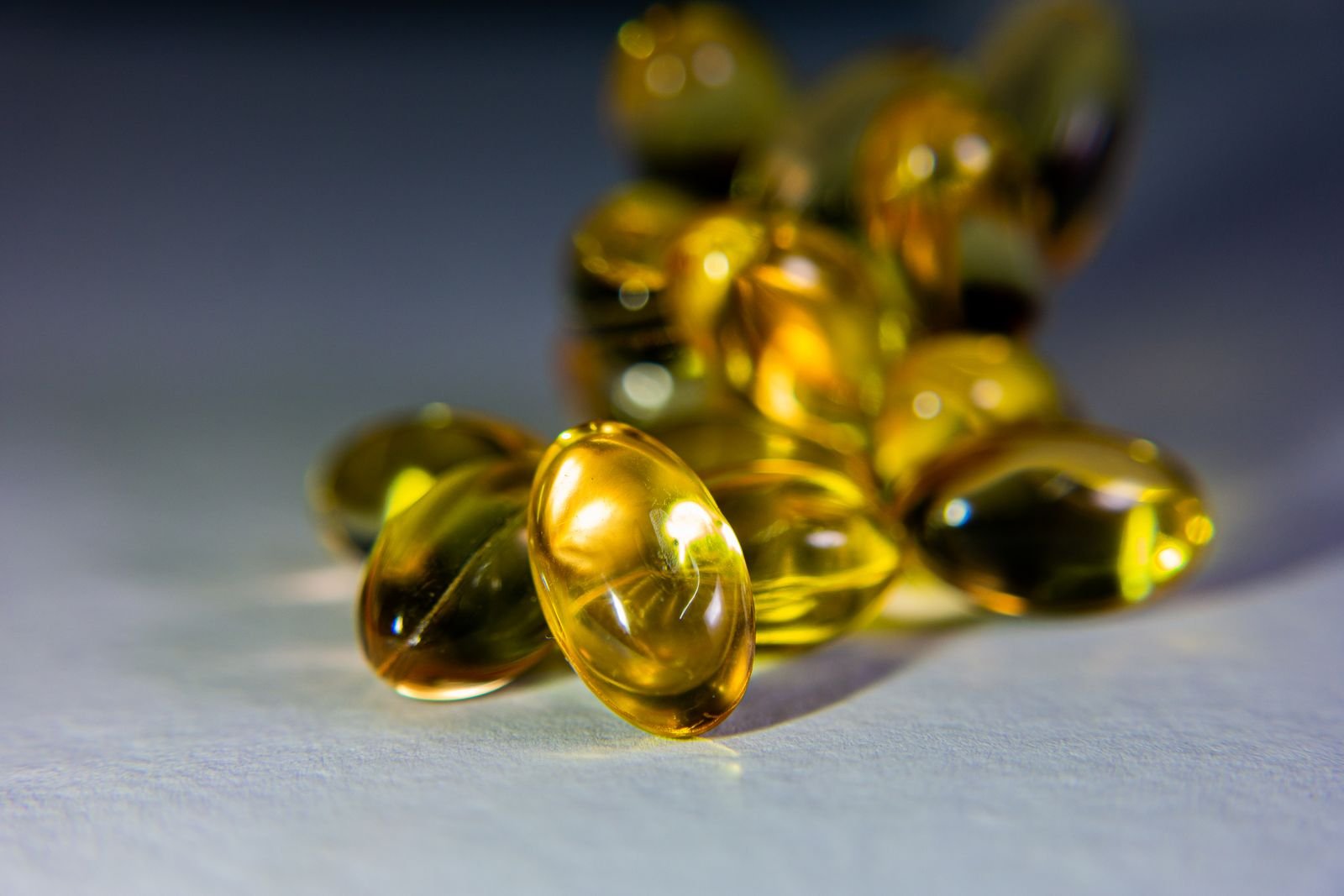 Golden fish oil softgel capsules close up